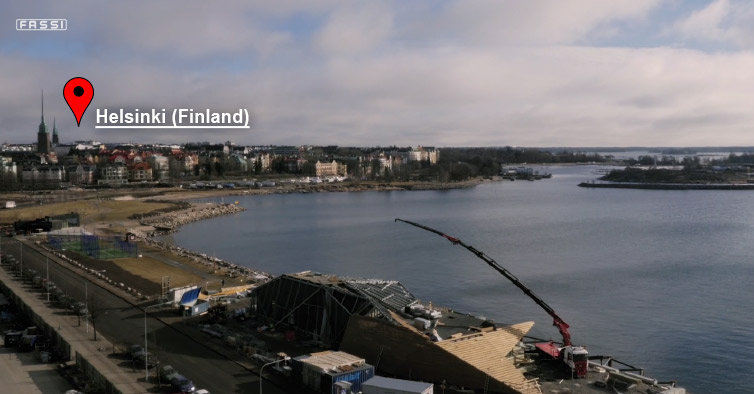 Fassi-F2150RAL-knuckle-boon-crane-in-action-on-a-building-site-near-Helsinki